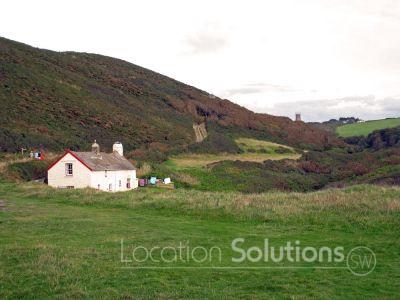 Isolated cottage in valley above beach