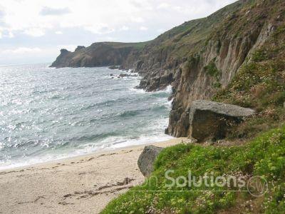 Secluded Sandy Beach with Dramatic Cliffs