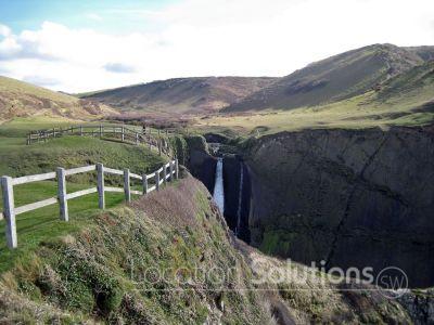 Dramatic unspoilt coastline with waterfall
